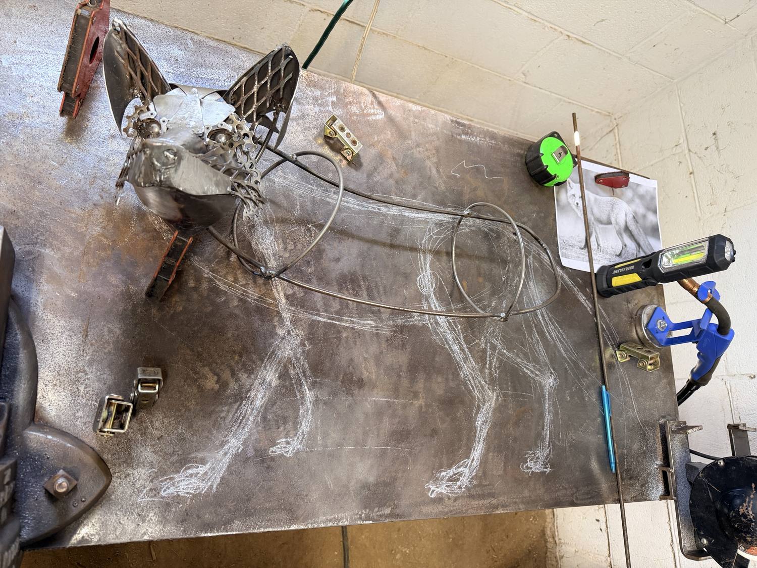 Franklin's head next to a chalk outline of the body sketched on the work table
