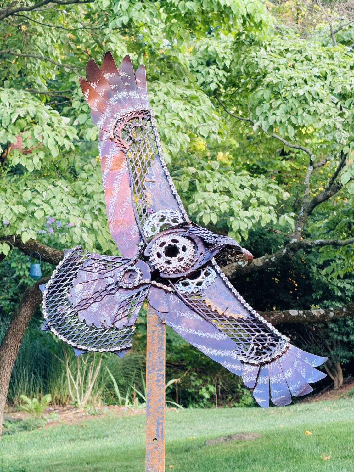 Sentinel viewed from below in flight, showing bicycle gears and chain worked into the wings